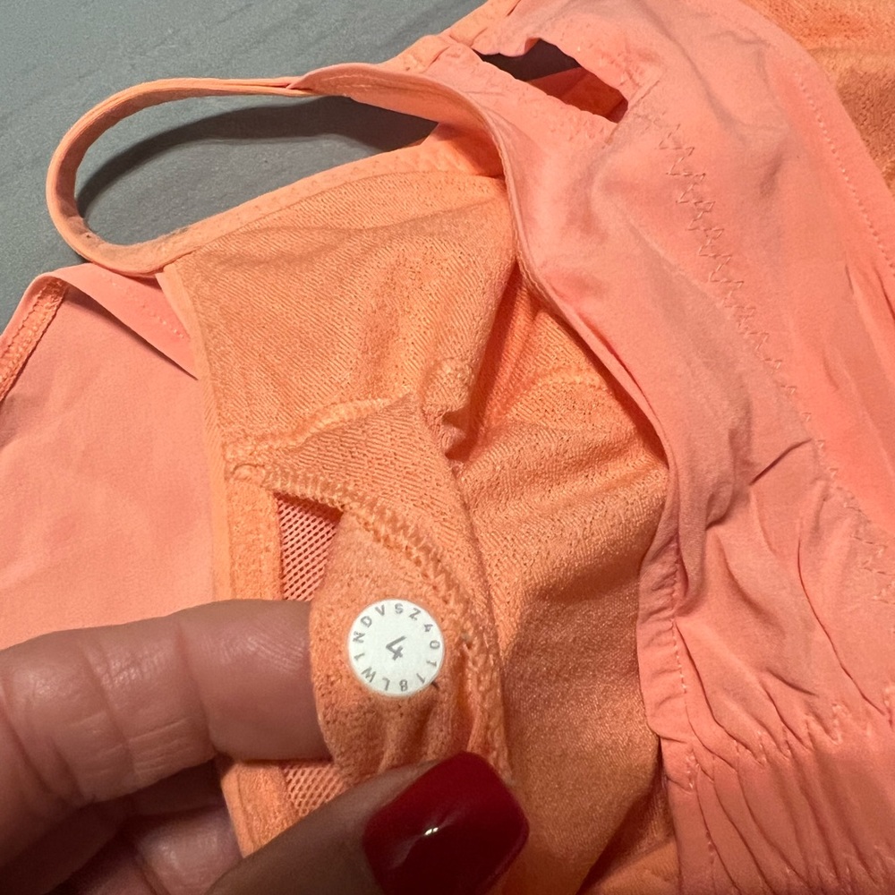 Lululemon tank.  Unique style.   Peach colored.  Barely worn.Size 4.Built in bra